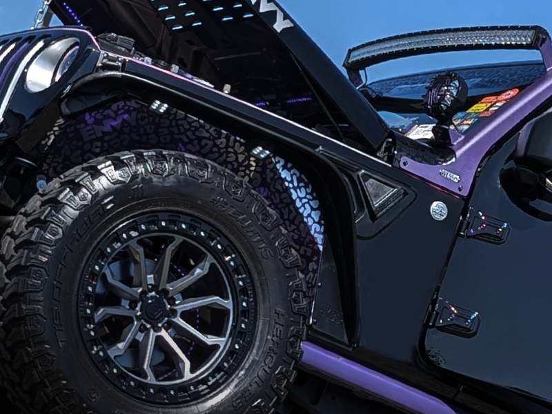 Shiny black and purple Jeep on display at OBX Jeep Invasion Show & Shine competition.